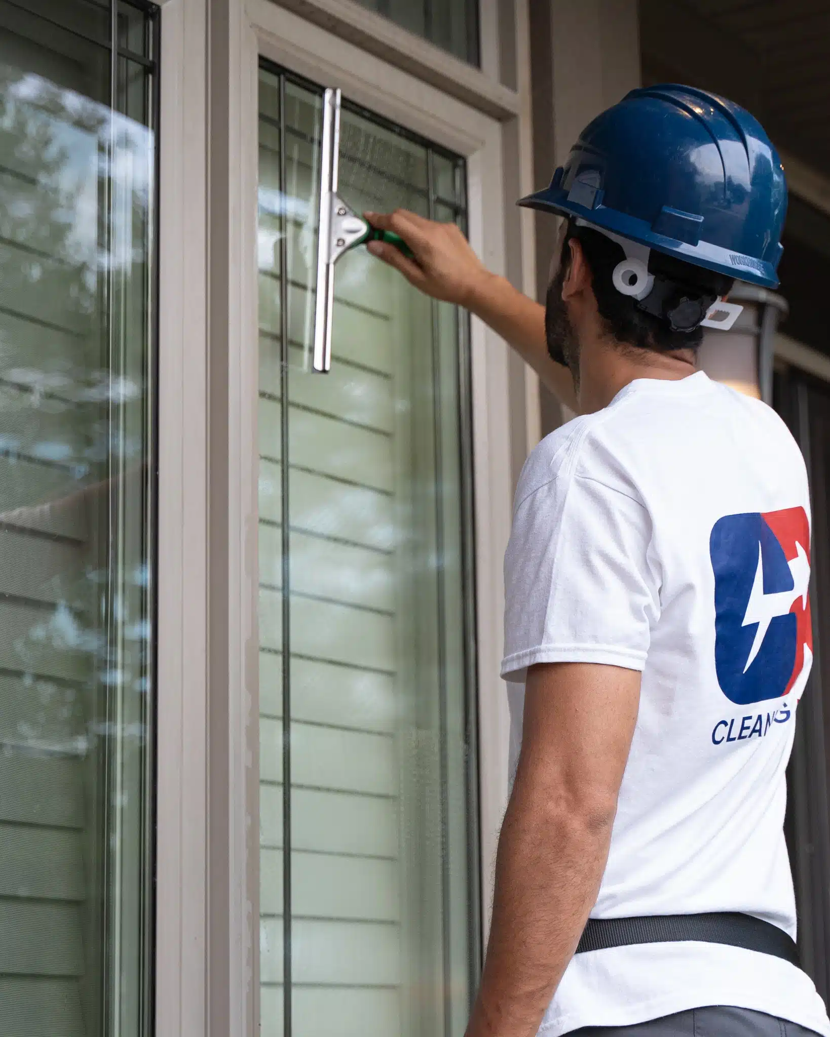 CR Cleaning Pros team cleaning a window of a home in Kitchener